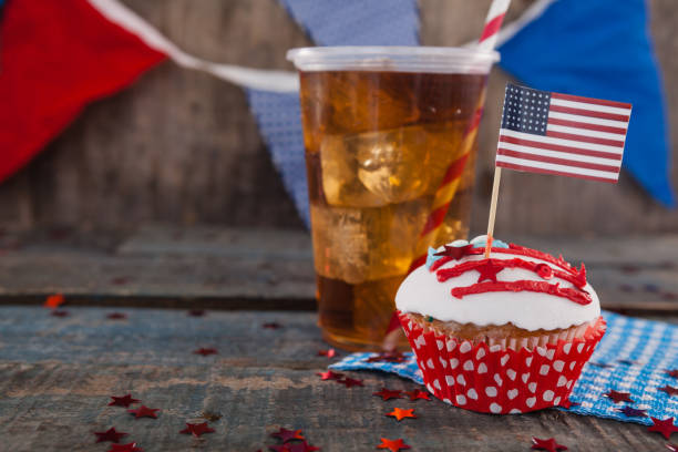 Decorated cupcake and cold drink with 4th july theme Decorated cupcake and cold drink with 4th july theme on wooden table 70s theme stock pictures, royalty-free photos & images