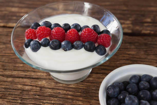 istock Fruit ice cream and blueberry on wooden table 801030474