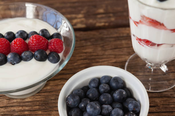 istock Fruit ice cream and blueberry on wooden table 801030522