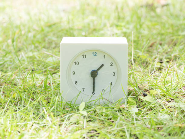 istock White simple clock on lawn yard, 1:30 one thirty o'clock 801035722