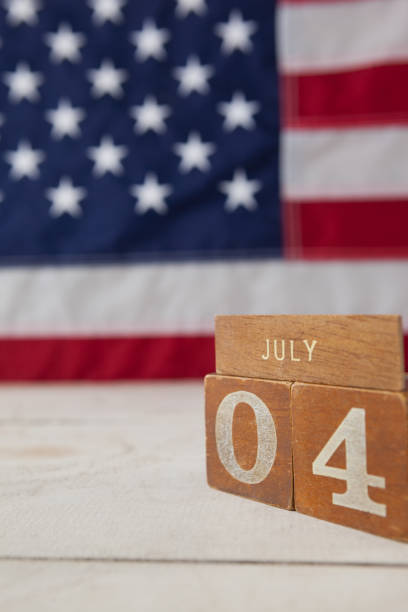 istock Date blocks arranged against American flag background 801041038