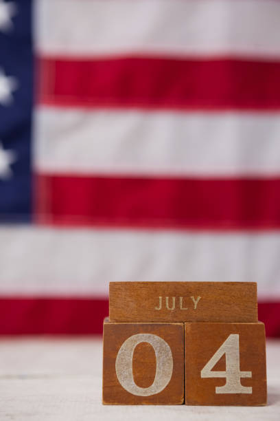 Close-up of date blocks arranged against American flag background