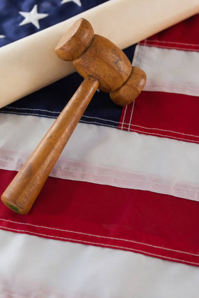 istock Gavel and rolled-up document arranged on American flag 801048674