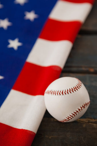 Close-up of baseball ball on American flag