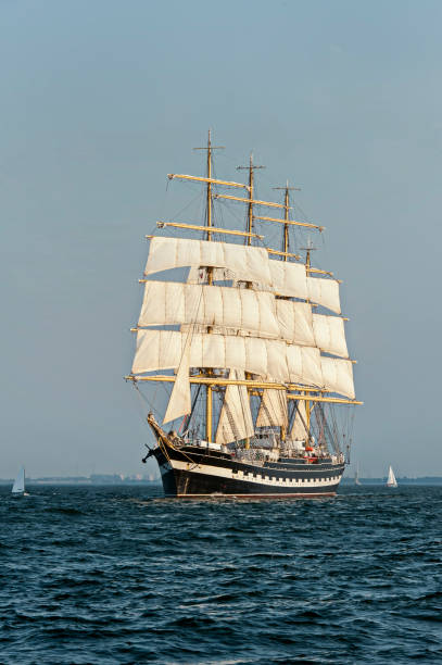 istock Tall Ship under sail with the shore in the background 801056778