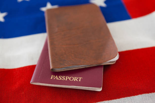 Close-up of passport and visa on an American flag