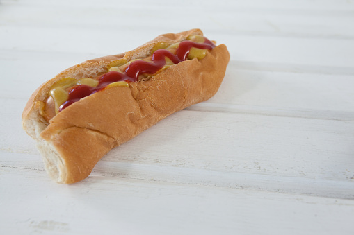 Close-up of hot dog on wooden table
