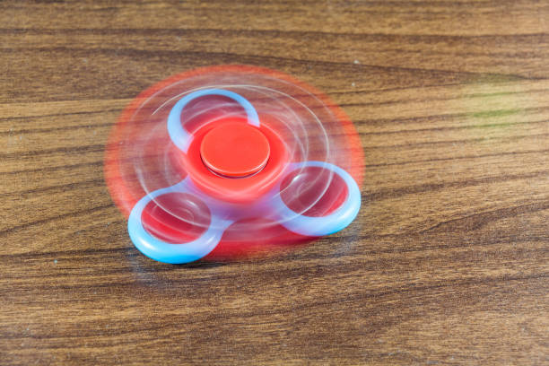 istock Fidget Spinner in wooden isolated background 801066250
