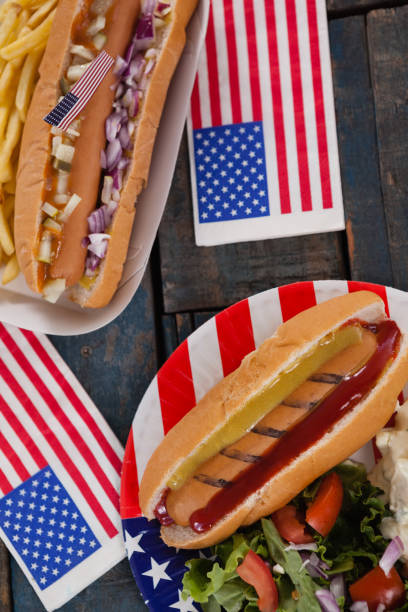 istock Hot dog and American flag on wooden table 801066488