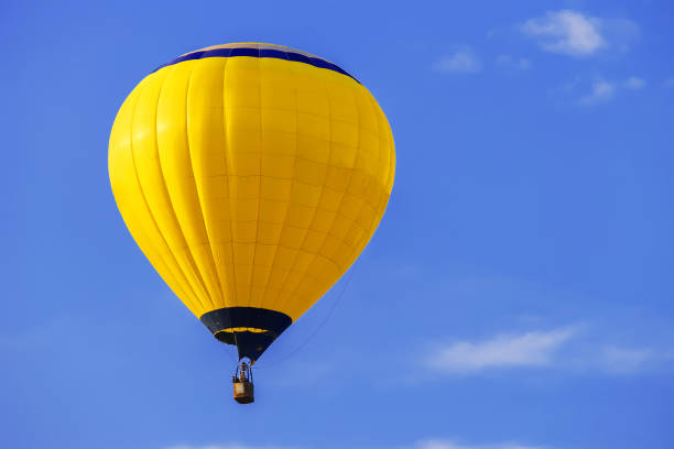 istock Yellow balloon in blue sky 801066650