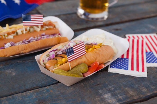 Hot dogs decorated with 4th july theme Hot dogs decorated with 4th july theme on wooden table 70s theme stock pictures, royalty-free photos & images