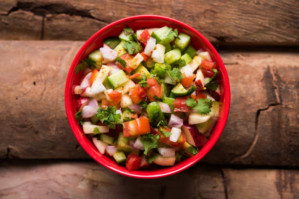 istock Kachumber or indian green salad served in red or white bowl, selective focus 801074300