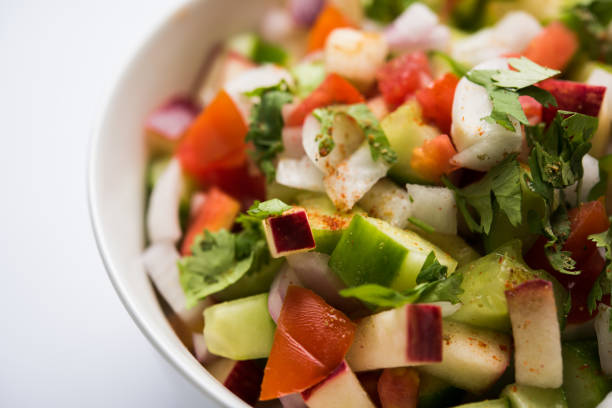 istock Kachumber or indian green salad served in red or white bowl, selective focus 801074688
