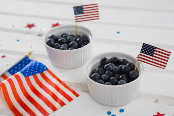 Black berries decorated with 4th july theme Black berries decorated with 4th july theme on wooden table 70s theme stock pictures, royalty-free photos & images