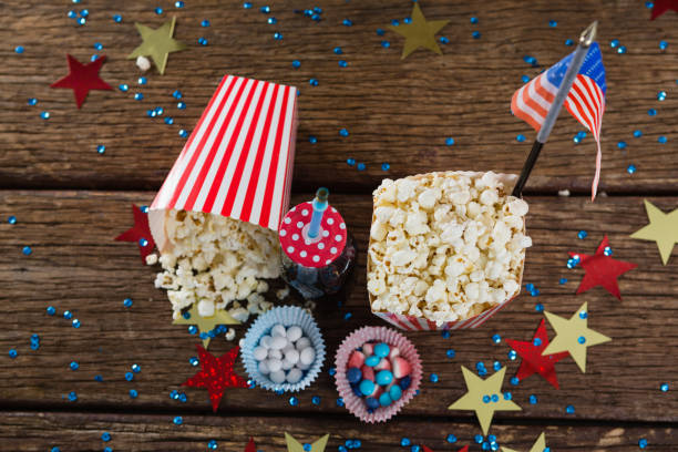 Popcorn, sweet food and cold drink decorated with 4th july theme Popcorn, sweet food and cold drink decorated with 4th july theme on wooden table 70s theme stock pictures, royalty-free photos & images