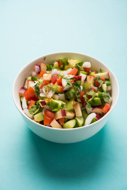 istock Kachumber or indian green salad served in red or white bowl, selective focus 801077786