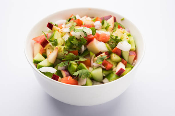 istock Kachumber or indian green salad served in red or white bowl, selective focus 801079940