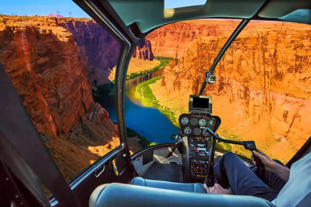 Helicopter cockpit with pilot arm and control console inside the cabin on the Grand Canyon Lake Powell. Reserve on the Colorado River, straddling the border between Utah and Arizona. USA, America.