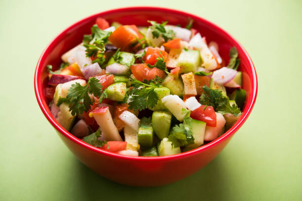 istock Kachumber or indian green salad served in red or white bowl, selective focus 801080224