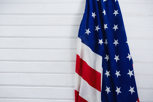 Close-up of an American flag on wooden background