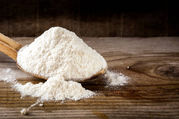 istock Organic wheat flour in wooden spoon 801096078