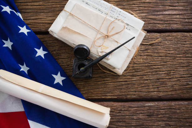 istock American flag with rolled-up of constitution document 801097940
