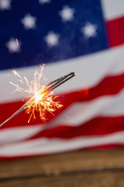 istock Sparklers burning against American flag background 801102706