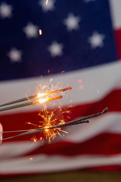 istock Sparklers burning against American flag background 801102736