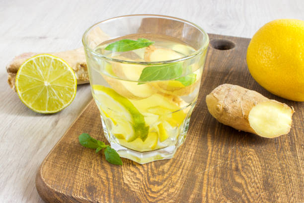 istock Ginger ale soda with lemon, mint, ginger and ice over rustic wooden background 801105282
