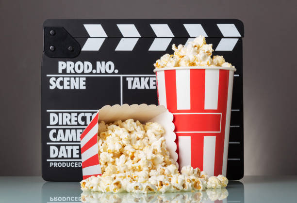 istock Popcorn in boxes and spilled, poppers on gray background. 801110140