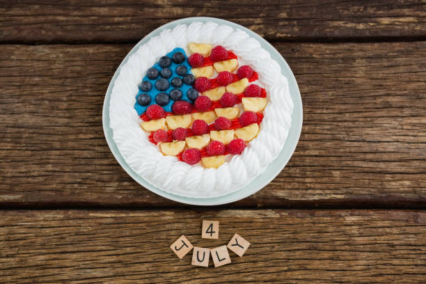 istock Date blocks and fruitcake on wooden table with 4th july theme 801111134