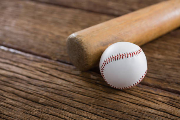 istock Baseball bat and ball on wooden table 801113842