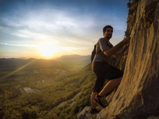 istock Young Mountain Climber on his Way to the Top 801120818