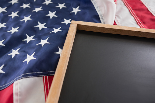 Close-up of American flag and slate