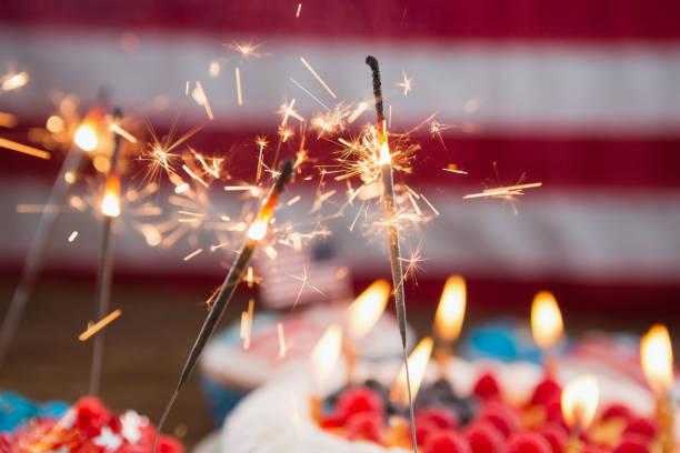Patriotic 4th of july cake and cupcake arranged on wooden table