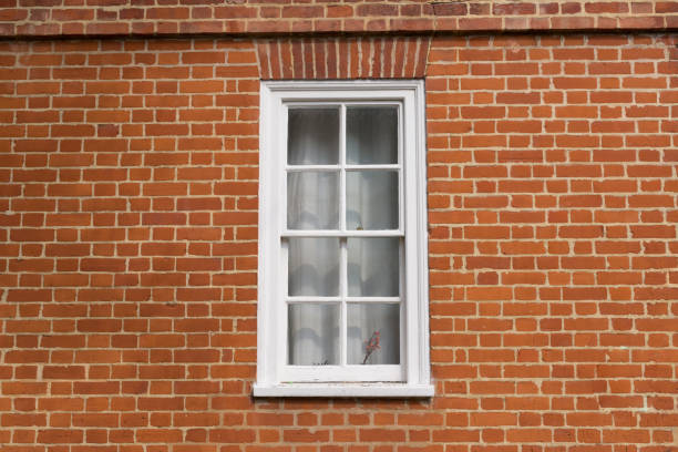 istock White vintage wooden window on a restored red brick wall 801122776