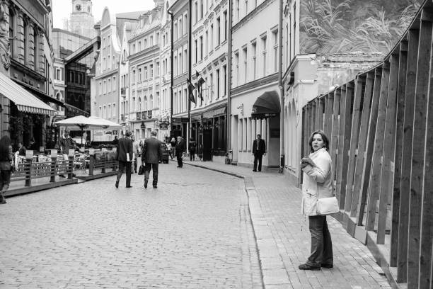 tourists on Tirgonu Iela street in Old Riga Town Riga: tourists on Tirgonu Iela street near Doma Laukums (Duomo) square in Old Riga Town in autumn. Riga city historical centre is a UNESCO World Heritage Site dome square stock pictures, royalty-free photos & images