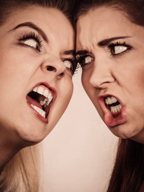 istock Two agressive women having argue fight 801127612