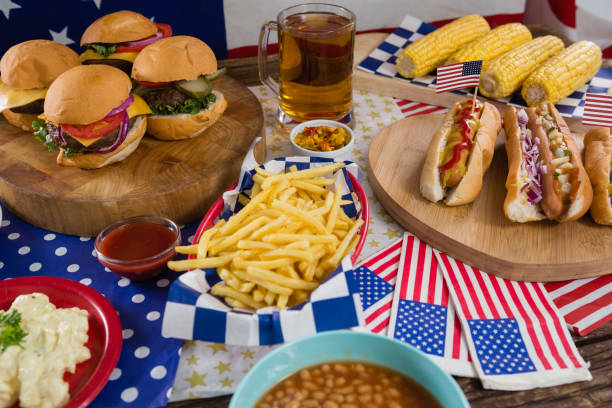 Hot dogs and burgers on wooden table with 4th july theme Close-up of hot dogs and burgers on wooden table with 4th july theme 70s theme stock pictures, royalty-free photos & images