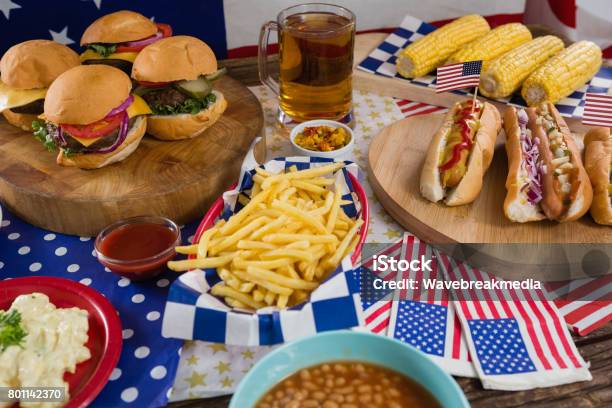 Hot Dogs And Burgers On Wooden Table With 4th July Theme Stock Photo - Download Image Now