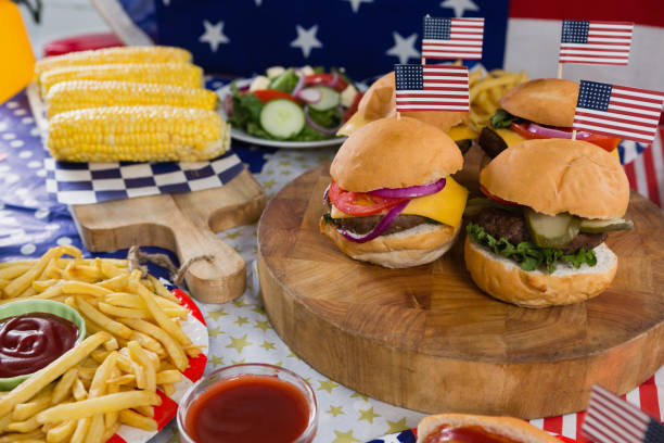Burgers and corn cob on wooden table with 4th july theme Close-up of burgers and corn cob on wooden table with 4th july theme 70s theme stock pictures, royalty-free photos & images
