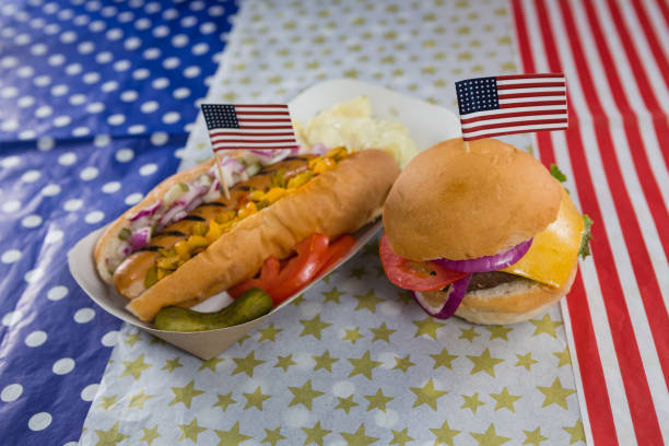 Burger and hot dog on wooden table with 4th july theme Close-up of burger and hot dog on wooden table with 4th july theme 70s theme stock pictures, royalty-free photos & images