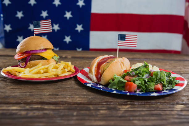 istock Burger and hot dog on wooden table with 4th july theme 801142588