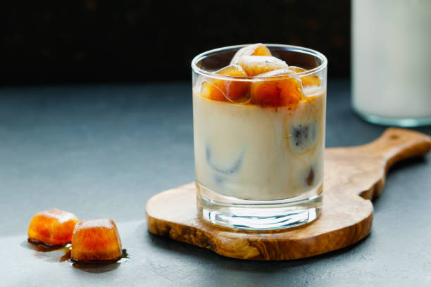 istock Iced coffee with milk on a wooden board on a black table. 801187138