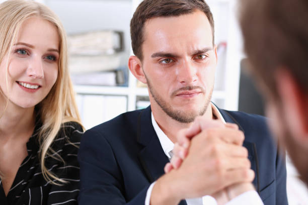 istock Woman and man in suit hold hands in wrestle 801187592