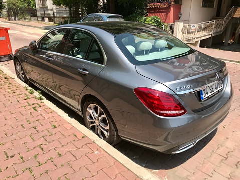 Istanbul,Turkey-June 24,2017:Rear and side view of a  Mercedes c200d.As a background there are a pedestrian way and street