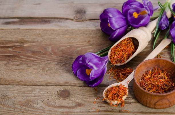 istock crocus flowers and spoon with soffron  on wooden table 801204102