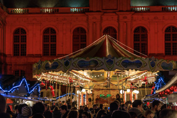 Rennes, France - December 10th, 2016: - A merry-go-around entertains the children at the Christmas market in Rennes in Brittany.  Rennes is the capital of the region.  The market is large enough to be divided between several squares, and this is the food market.