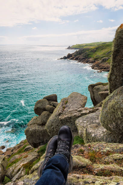 istock POV of man's walking boots, resting on Clifftop above Cornish Coast. 801224574