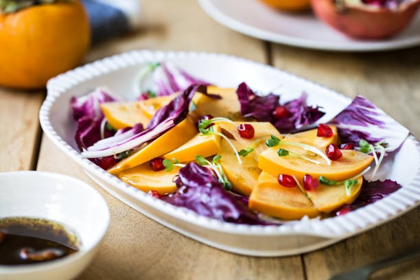 istock Persimmon with Radicchio and Pomegranate salad by Balsamic dressing 801231014